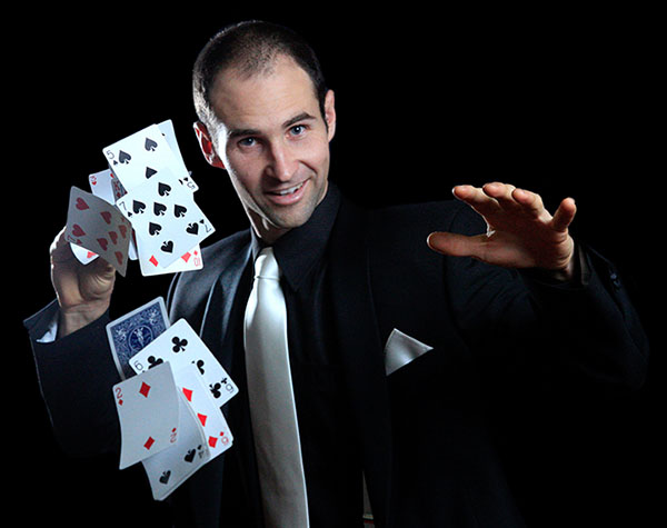 Craig performing with playing cards