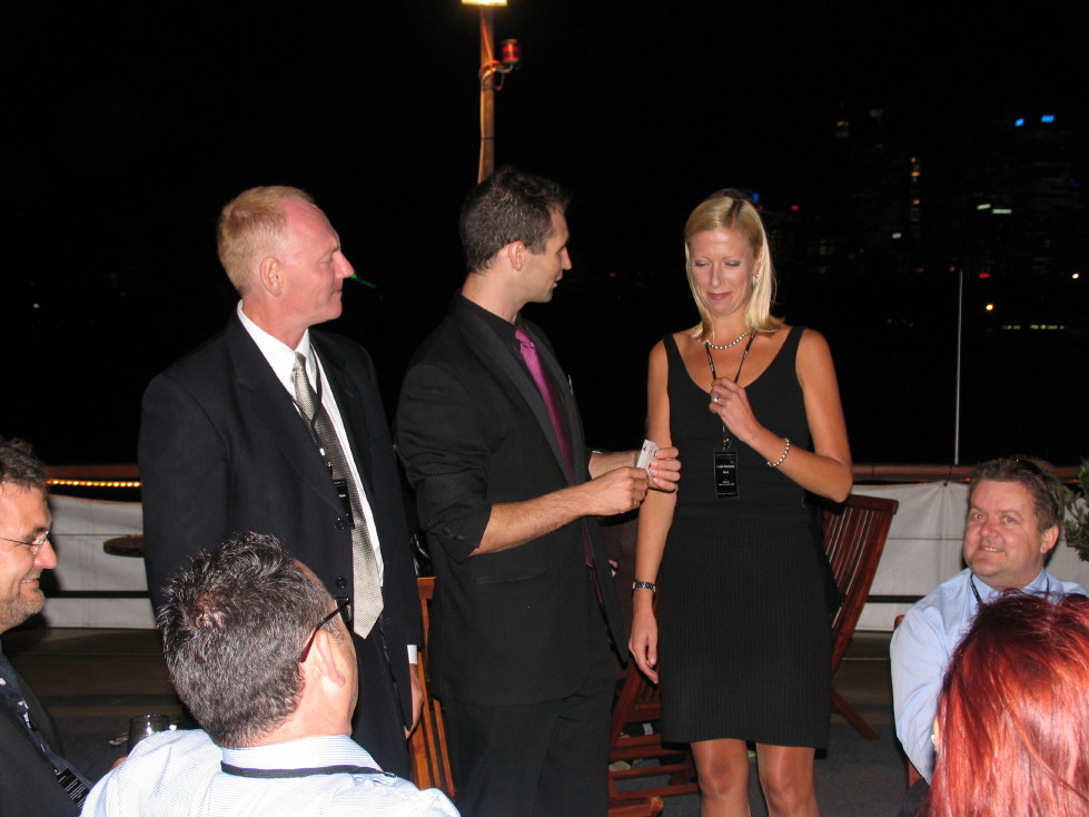 Tommy engaging guests with close-up magic at an evening event