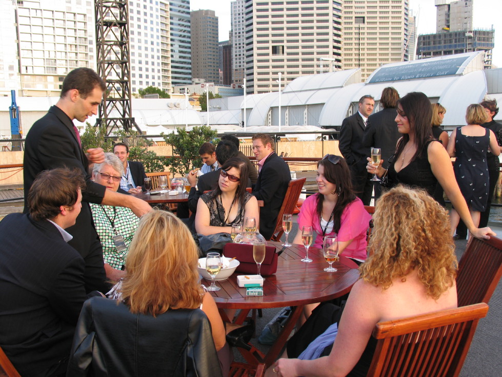 Tommy performing close-up magic for guests at an outdoor reception